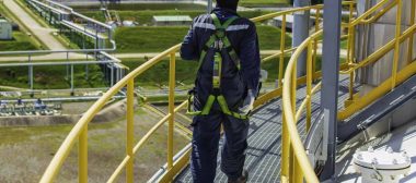 Male worker wearing safety harness